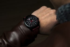 A man looking at the watch. Over the shoulder view. Horizontal shot. Image taken in studio.